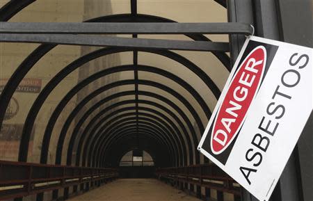 A warning sign hangs at a walkway leading to a closed-down hotel in downtown Gary, Indiana, August 28, 2013. REUTERS/Jim Young