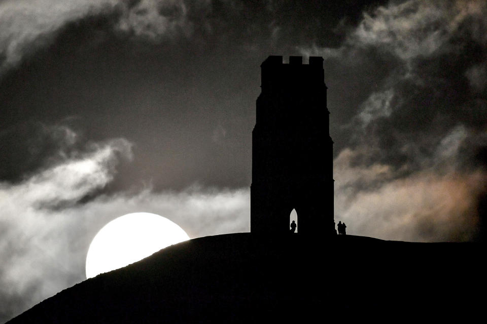 <p>A Blue Moon rises behind Glastonbury Tor, Somerset. (Photo: Ben Birchall/PA Images via Getty Images) </p>