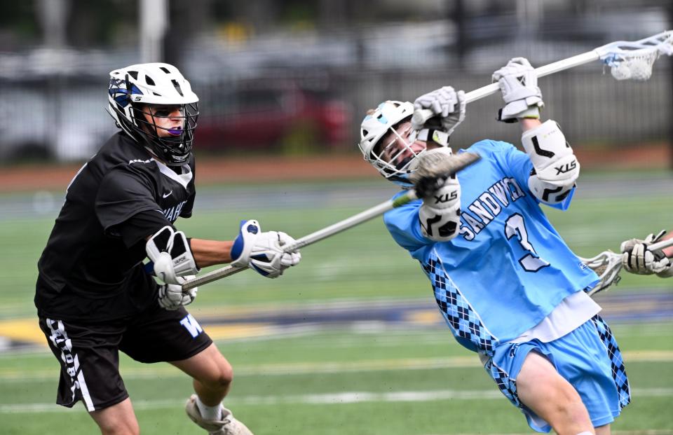 WORCESTER  6/22/22  Cole Rodgers of  Sandwich puts a shot on the  Wahconah Regional goal defended by Blake Casella in the  boys Division 4 Final lacrosse match.