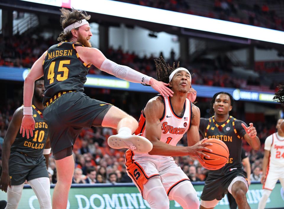 Jan 10, 2024; Syracuse, New York, USA; Syracuse Orange forward Maliq Brown (1) is fouled by Boston College Eagles guard Mason Madsen (45) during a shot in the second half at the JMA Wireless Dome. Mandatory Credit: Mark Konezny-USA TODAY Sports