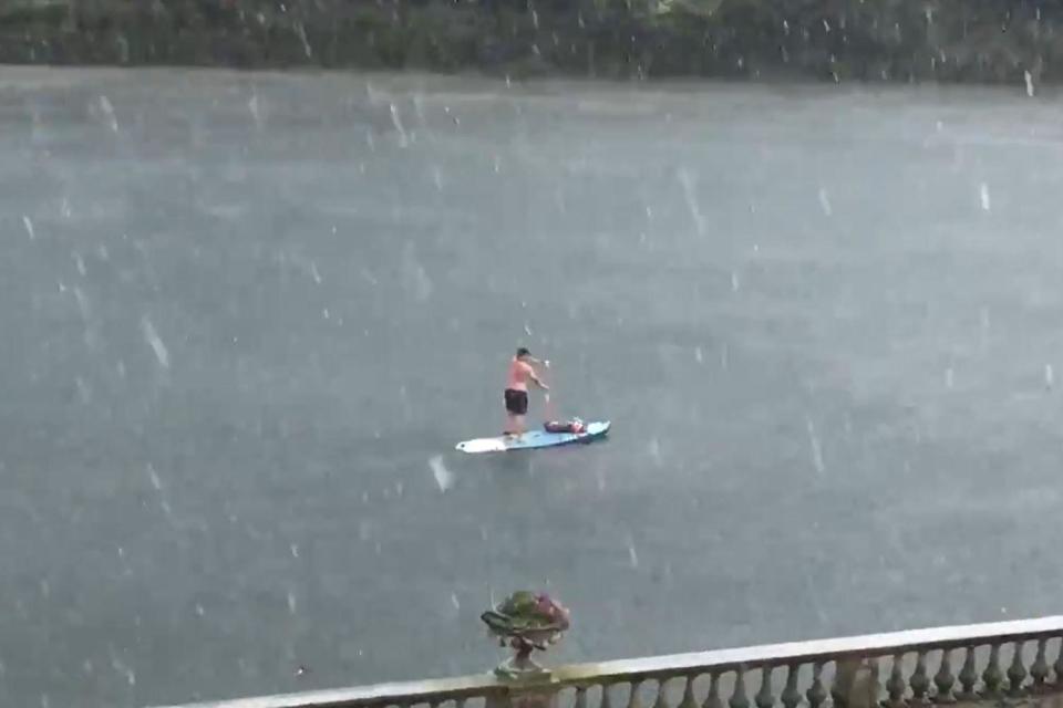 A man paddle boarded on the River Thames during heavy hail storms as the heatwave came to an end (PA/@ruths_gallery )