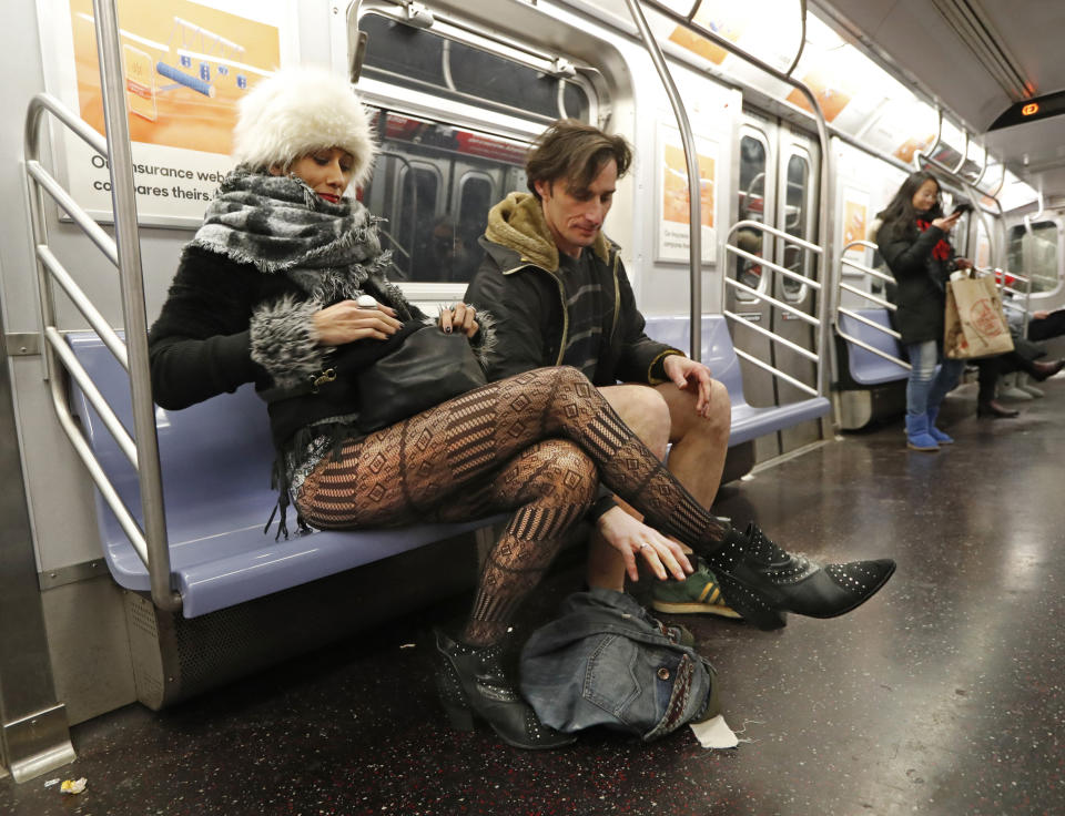 Leon Feingold, right, drops his jeans as his girlfriend Patrizia Calvio looks in her purse on the uptown E Train during the 18th annual No Pants Subway Ride, Jan. 13, 2019, in New York. (Photo: Kathy Willens/AP)