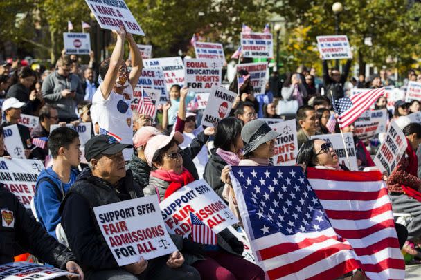 PHOTO: Demonstrators against Harvard University's admission process hold signs and American flags while gathering during a protest at Copley Square in Boston, Oct. 14, 2018. (Adam Glanzman/Bloomberg via Getty Images, FILE)