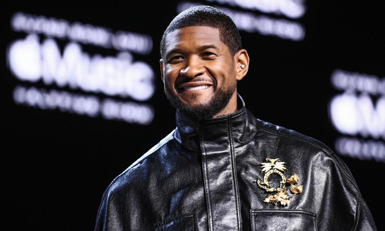 <span>Usher speaks on stage during the Super Bowl press conference.</span><span>Photograph: PA Wire/PA</span>