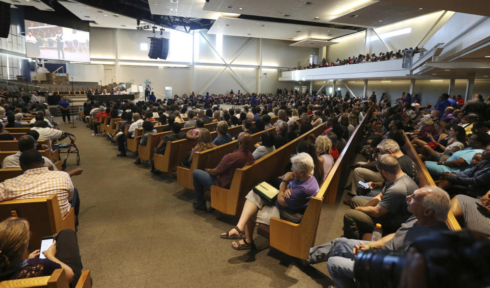 FILE - In this June 18, 2019 file photo people attend a community meeting in Phoenix. Still stinging from national outrage sparked this summer by a videotaped encounter of officers pointing guns and cursing at a black family, community members are holding low-key meetings aimed at helping Phoenix officials figure out how citizens could help oversee the city's officers. (AP Photo/Ross D. Franklin,File)