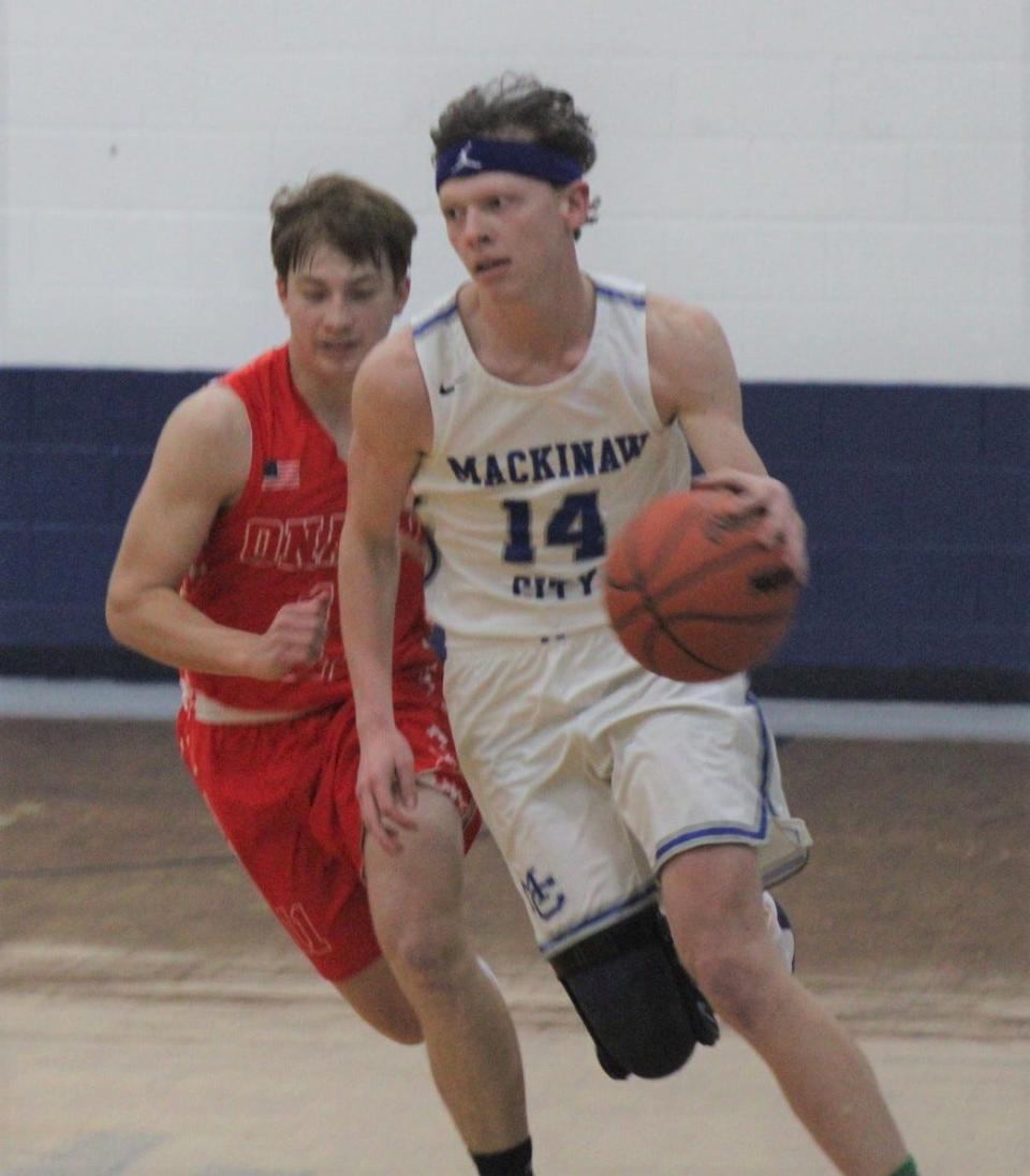 Senior Lars Huffman (14) was one of four double-digit scorers who helped lead the Mackinaw City boys basketball team past Wolverine on Monday.