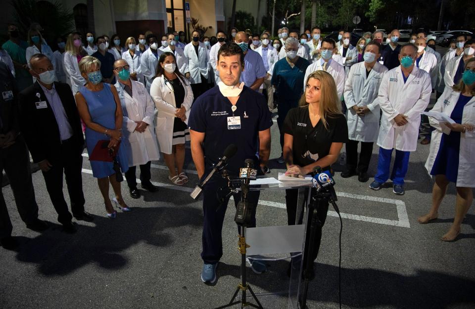 Emergency Room physicians Dr. Ethan Chapin and Dr. JT Snarski speak out as a group of doctors and administrators gathered in Palm Beach Gardens early Monday morning, August 23, 2021 to support vaccinations and the wearing of masks in their fight against COVID-19.  The entire physician staff of Palm Beach Gardens Medical Center was invited, as well as doctors from other area hospitals. 