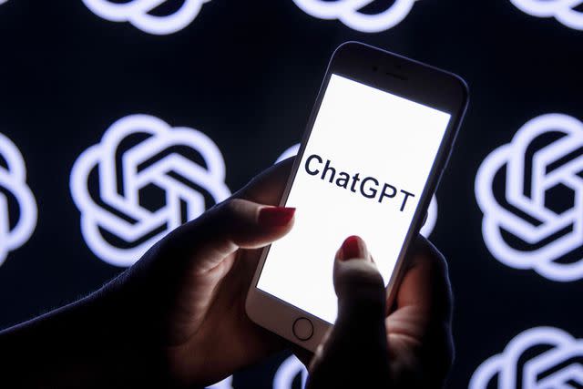 <p>Didem Mente/Anadolu Agency via Getty</p> Stock image of a phone and the ChatGPT logo