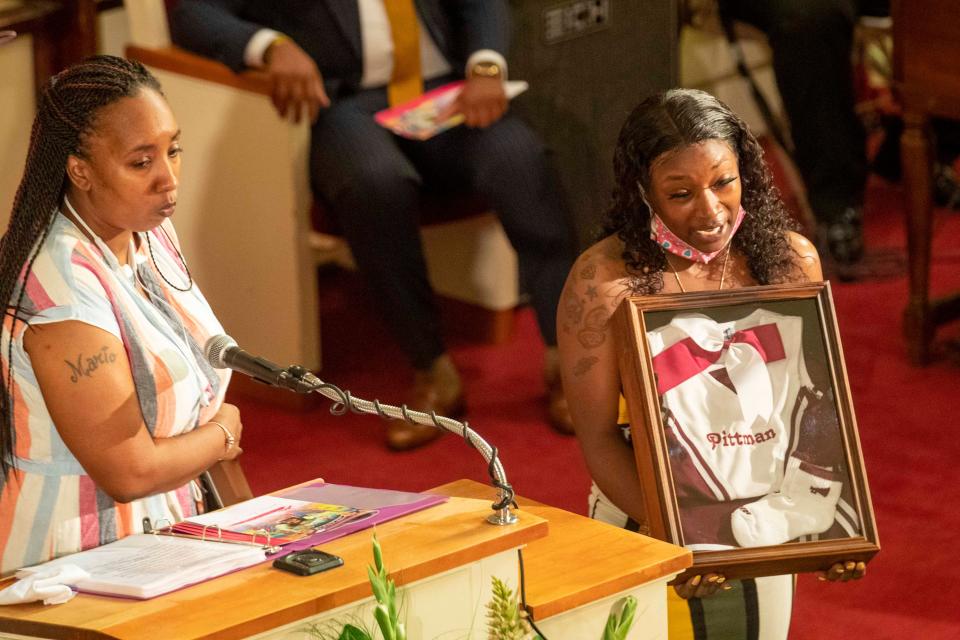 Secoriea Turner's cheerleading uniform is presented to her mother by a former coach during Secoriea's home-going service at New Calvary Missionary Church in Atlanta's Sylvan Hills community, Wednesday, July 15, 2020. On July 4, 8-year-old Secoriea was shot dead by armed civilians in Atlanta.