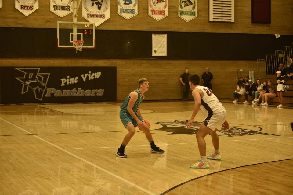 Andrew Barnes (teal) and Bensen Shepherd (white) battled all night on Monday in the Panthers' narrow overtime win over Canyon View.