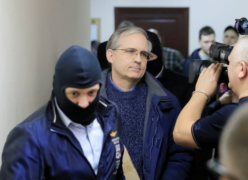 Former U.S. Marine Paul Whelan, who was detained and accused of espionage, is escorted inside a court building in Moscow
