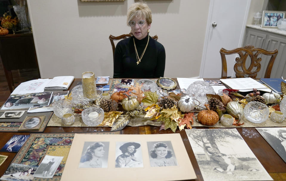 Sitting among photos of her late mother Doris Gleason, Shanon Dion talks about her in Carrolton, Texas, Wednesday, Nov. 3, 2021. Gleason was one of 18 women in the Dallas area that Billy Chemirmir is charged with capital murder and he is suspected in several more deaths. Most of the deaths happened at upscale independent living communities for older people, where Chemirmir has been accused of forcing his way into apartments or posing as a handyman, and in a couple instances was even caught trespassing. (AP Photo/LM Otero)