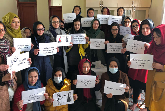 FILE-Afghan women chant and hold signs of protest, in Kabul, Afghanistan, Monday, Dec. 27, 2021. A U.K.-based rights group on Thursday, May 18, 2023 launched an interactive map documenting human rights abuses and violence against civilians since the Taliban seized power in Afghanistan nearly two years ago. (AP Photo/Mohammed Shoaib Amin, File)