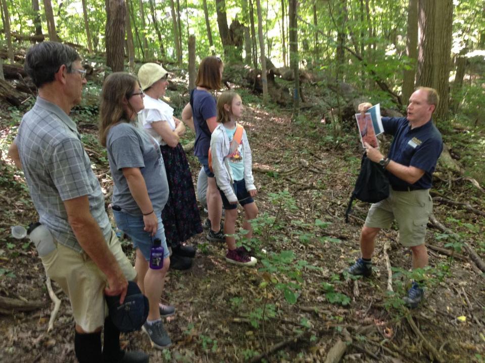 A naturalist-led hike returns to the woods at Elbel Park Golf Course in South Bend. Here, city naturalist Garry Harrington leads the hike in a recent year.