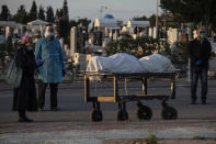 A family member speaks during the funeral of a Jewish man who died from coronavirus in the costal city of Ashkelon, Israel, Thursday, April 2, 2020. (AP Photo/Tsafrir Abayov)