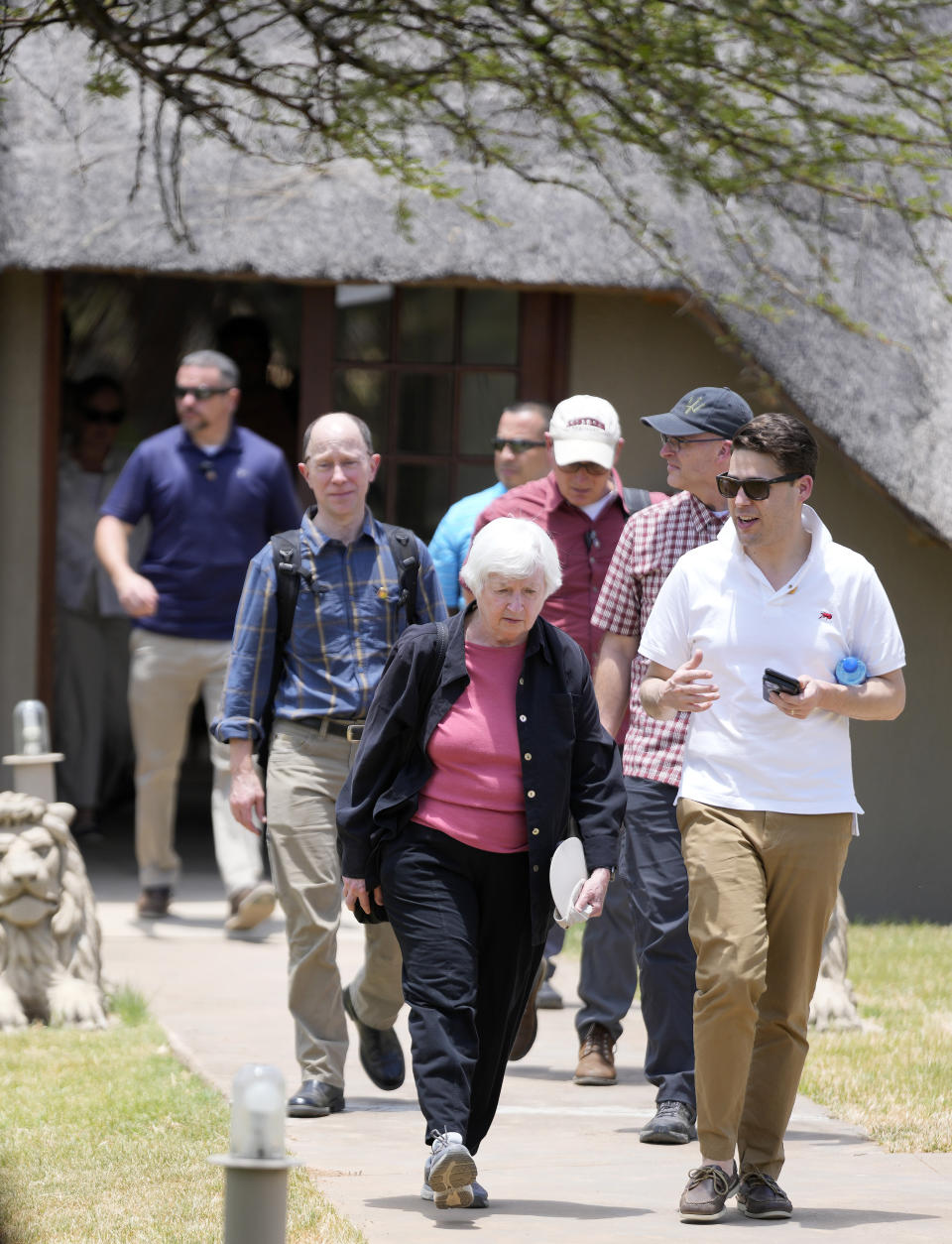 U.S. Treasury Secretary Janet Yellen, left, with her officials walks to a meeting at Dinokeng Game Reserve in Hammanskraal, north of Pretoria, South Africa, Wednesday, Jan. 25, 2023, as part of a Treasury ten-day tour of Africa, with stops in Senegal, Zambia and South Africa. (AP Photo/Themba Hadebe)