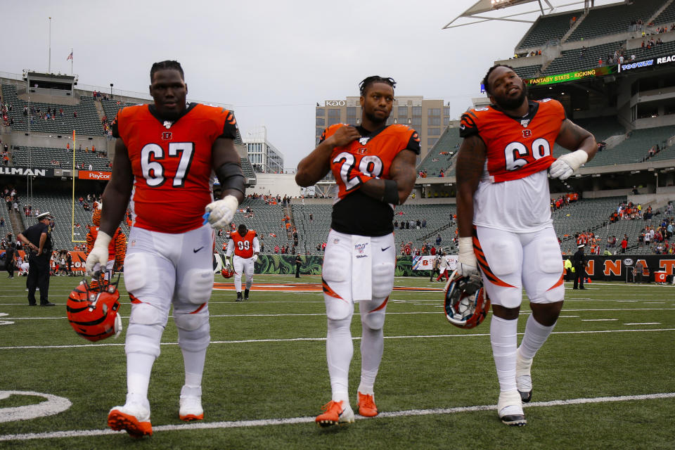 Cincinnati Bengals offensive guard John Miller (67), running back Joe Mixon (28), and offensive tackle Bobby Hart (68) walk off the field after losing an NFL football game against the Arizona Cardinals, Sunday, Oct. 6, 2019, in Cincinnati. (AP Photo/Gary Landers)