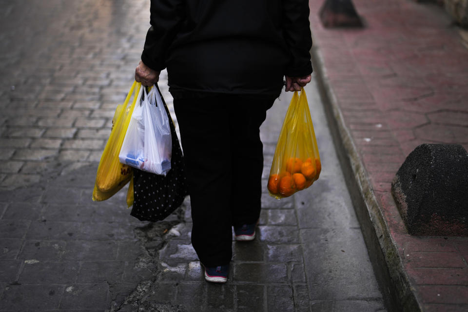 A woman carries bags with food after shopping in Istanbul, Turkey, Wednesday, Feb. 7, 2024. Turkey's new Central Bank chief says tight fiscal policies to tame inflation will continue "with determination" forecasting a 14 per cent inflation rate by the end of 2025. (AP Photo/Francisco Seco)