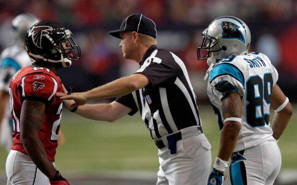 FILE: Side Judge Carl Cheffers (#51) separates Atlanta Falcons’ DeAngelo Hall (#21, left) and Carolina Panthers Steve Smith (#89) in the 3rd quarter at the Georgia Dome in Atlanta, GA. Hall was called for an Unsportsmanlike Conduct to keep the Panthers drive alive. The Panthers won, 27-20. DAVID T. FOSTER III-dtfoster@charlotteobserver.com