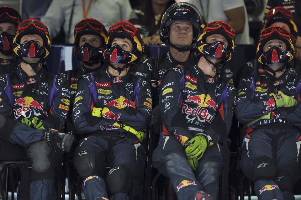 The Red Bull Formula One crew watch the Brazilian F1 Grand Prix race at the Interlagos circuit in Sao Paulo