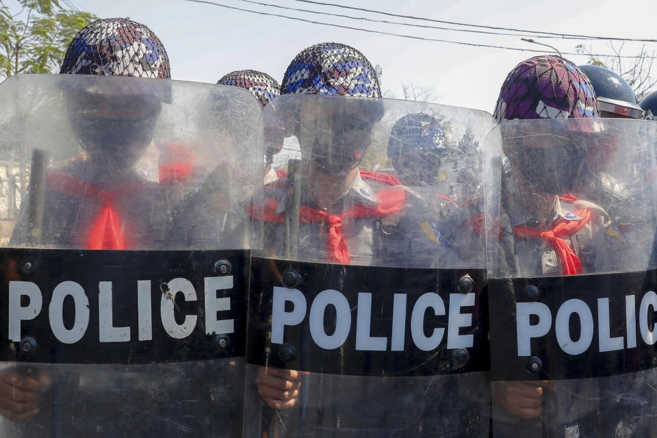 Police in riot gear march to take a position blocking demonstrators at an intersection during a protest in Mandalay, Myanmar, Tuesday, Feb. 9, 2021. Police were cracking down on the demonstrators against Myanmar’s military takeover who took to the streets in defiance of new protest bans. (AP Photo)