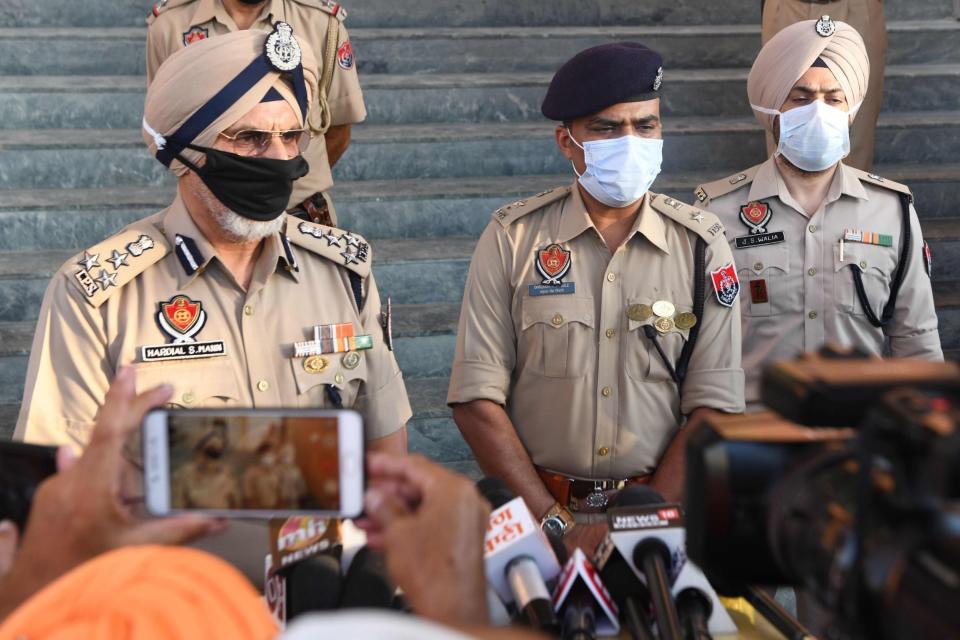 Punjab police speak to the media after 67 people died from drinking tainted alcohol: AFP via Getty Images