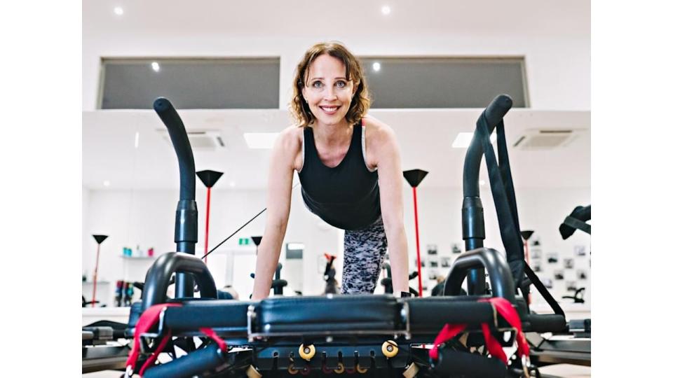 Woman on a megaformer Pilates machine 