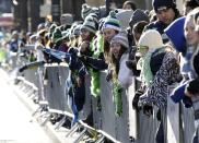 Fans stand along 4th Avenue at the Super Bowl victory parade for the Seattle Seahawks in downtown Seattle, Washington February 5, 2014. Up to 500,000 Seattle Seahawks fans were expected to brave sub-freezing temperatures to celebrate the football team's first Super Bowl title at the parade set to wind through the city's downtown on Wednesday. REUTERS/Jason Redmond (UNITED STATES - Tags: SPORT FOOTBALL)