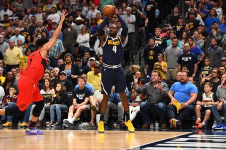 May 12, 2019; Denver, CO, USA; Denver Nuggets forward Paul Millsap (4) attempts a three-point basket over Portland Trail Blazers guard Evan Turner (1) in the fourth quarter in the second round of the 2019 NBA Playoffs at Pepsi Center. Mandatory Credit: Ron Chenoy-USA TODAY Sports