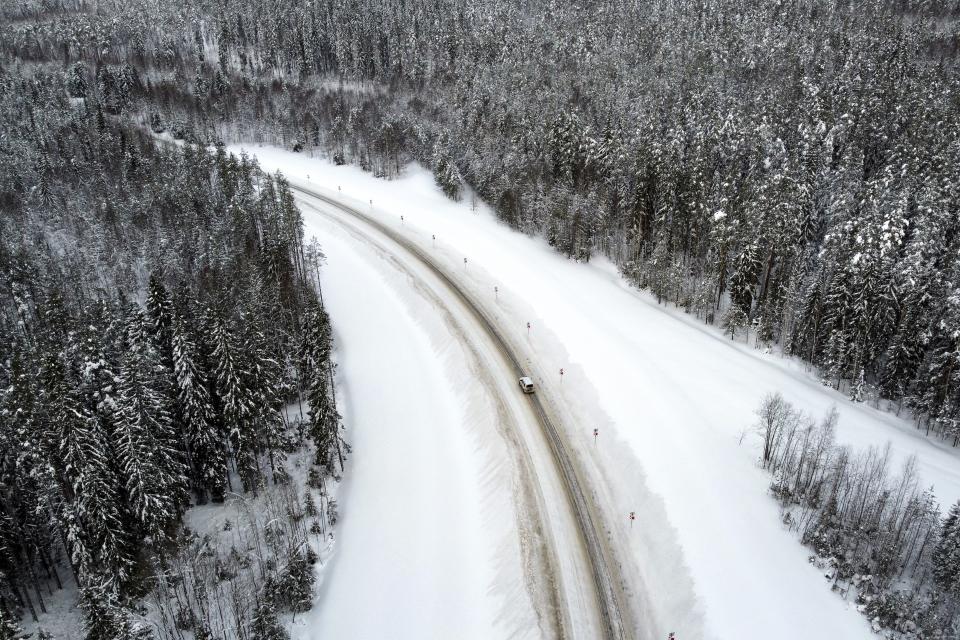 A medical car carrying COVID-19 vaccines drives to the village of Ikhala in Russia’s Karelia region, Tuesday, Feb. 16, 2021. Russia’s rollout of its coronavirus vaccine is only now picking up speed in some of its more remote regions, although experts say the campaign is still moving slowly. (AP Photo/Dmitri Lovetsky)