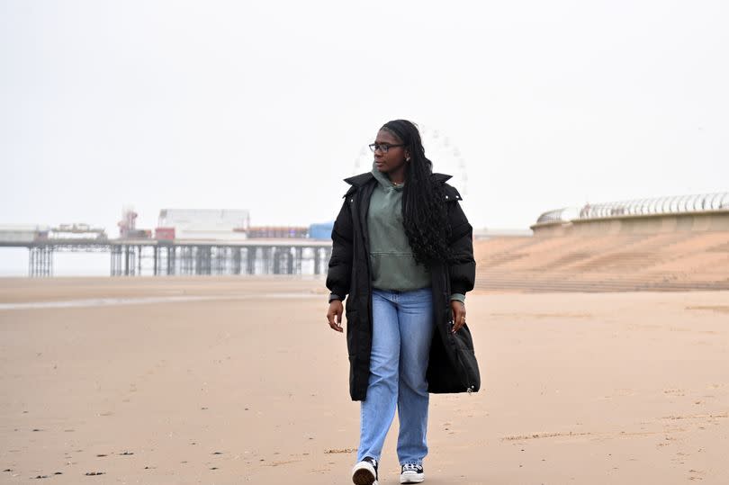 A photo of Jade walking along Blackpool Beach