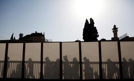 Non-Muslim visitors wait to enter the compound known to Muslims as Noble Sanctuary and to Jews as Temple Mount in Jerusalem's Old City July 24, 2017. REUTERS/Ronen Zvulun