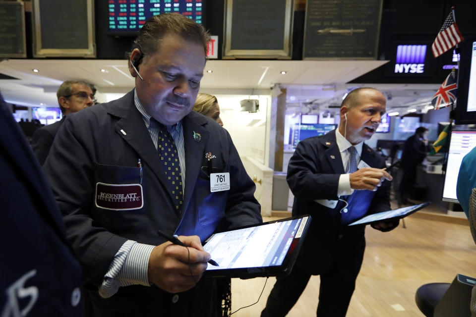 Traders John Santiago, left, and Michael Urkonis work on the floor of the New York Stock Exchange, Tuesday, June 11, 2019. Stocks are rising early Tuesday as Wall Street continues to thrive in June. (AP Photo/Richard Drew)