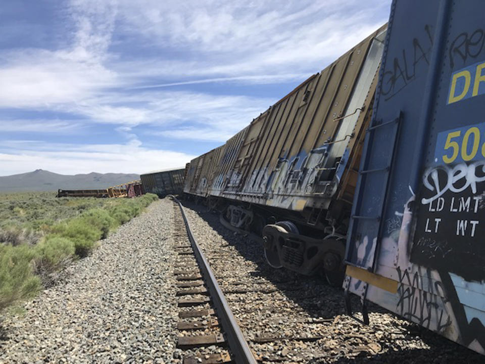 This photo provided by the Nevada Department of Public Safety shows a derailed train Wednesday, June 19, 2019, near Wells, Nev. A train carrying military munitions derailed in the high desert of northeast Nevada, closing an interstate for about an hour before emergency crews determined there was no danger. No injuries were reported. (Nevada Department of Public Safety via AP)