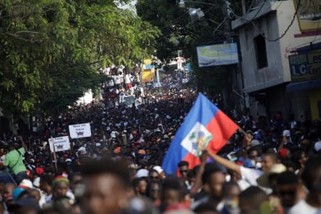 Protesters march during a demonstration called by artists to demand the resignation of Haitian president Jovenel Moise, in the streets of Petion Ville, Port-au-Prince