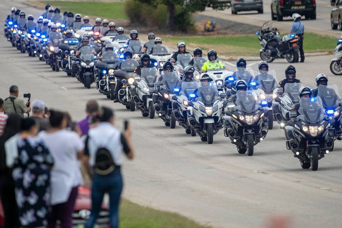 Law enforcement officer from across North Carolina ride their motorcycles in formation on Glenwood Avenue as they begin the procession to Wake County Deputy Ned Byrds funeral at Providence Baptist Church on Friday, August 19, 2022 in Raleigh, N.C.