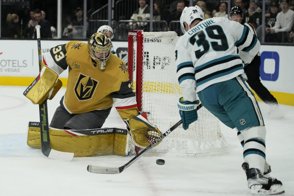 San Jose Sharks center Logan Couture (39) skates by Vegas Golden Knights goaltender Adin Hill (33) during the first period of an NHL hockey game Thursday, Feb. 16, 2023, in Las Vegas. (AP Photo/John Locher)