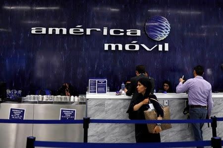 FILE PHOTO: The logo of America Movill is seen on the wall at the company's corporate offices in Mexico City, Mexico March 14, 2018. REUTERS/Carlos Jasso