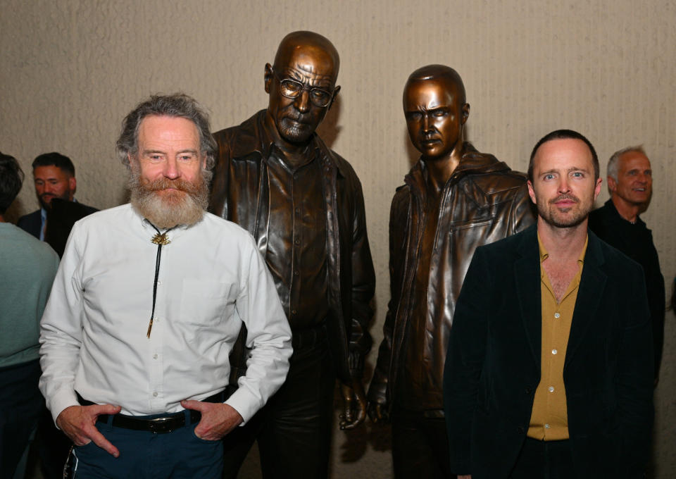 ALBUQUERQUE, NEW MEXICO - JULY 29:  Actor Bryan Cranston (L) and actor Aaron Paul pose with bronze statues depicting television characters Walter White, played by Cranston, and Jesse Pinkman, played by Paul, from the series 