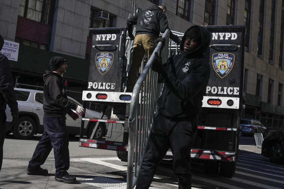 Barricades are unloaded from a truck near the courts in New York, Monday, March 20, 2023. (AP Photo/Seth Wenig)