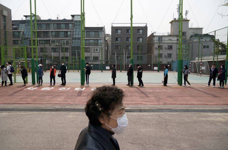 FILE PHOTO: People vote in South Korea's parliamentary election amid the coronavirus disease (COVID19) pandemic