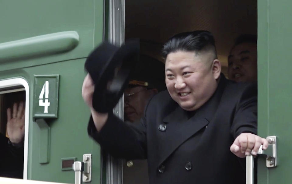 FILE - In this image from video released by Primorsky Regional Administration Press Service, North Korean leader Kim Jong Un waves from his train as he leaves Khasan train station in Primorye region, Russia, Wednesday, April 24, 2019. North Korean leader Kim Jong Un’s possible trip to Russia might be like his first one in 2019, a rattling, 20-hour ride aboard a green-and-yellow armored train that is a quirky symbol of his family’s dynastic leadership. (Primorsky Regional Administration Press Service via AP, File)