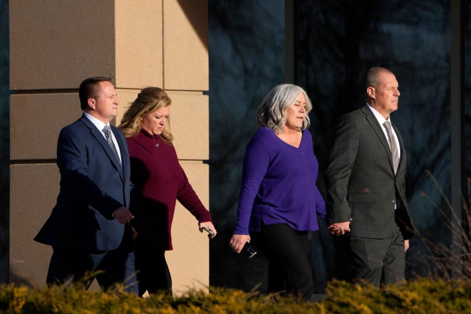 Paramedics Jeremy Cooper, far left, and Peter Cichuniec, far right, enter the Adams County, Colo., Justice Center, Friday 22 December (Copyright 2023 The Associated Press. All rights reserved.)