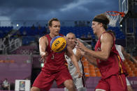 Belgium's Nick Celis (5) passes to teammate Thibaut Vervoort (2) as Latvia's Edgars Krumins watches during a men's 3-on-3 basketball game at the 2020 Summer Olympics, Saturday, July 24, 2021, in Tokyo, Japan. (AP Photo/Jeff Roberson)