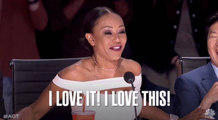 Mel B smiling and clapping in excitement on America's Got Talent. Text on image: "I LOVE IT! I LOVE THIS!"