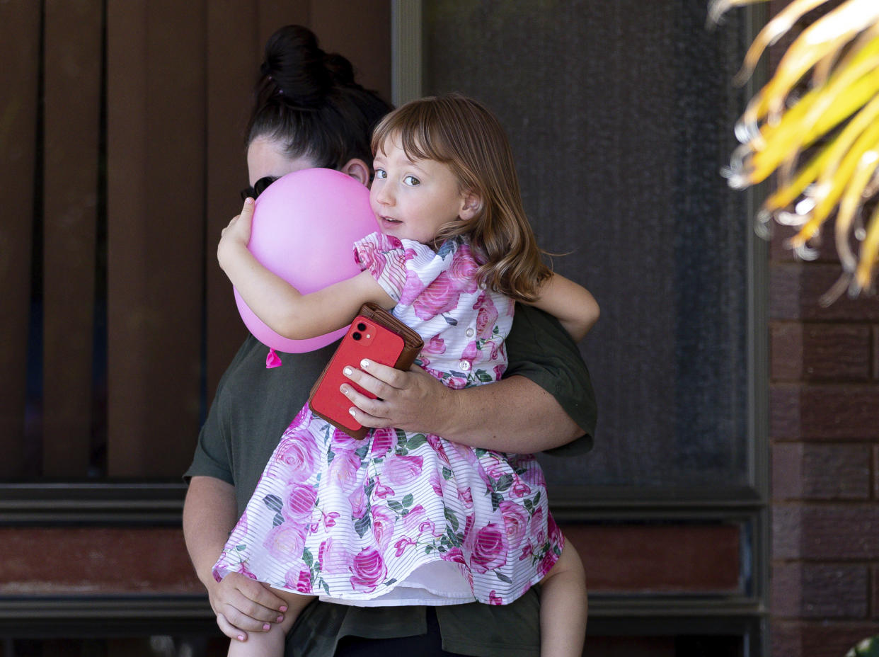 Cleo Smith, right, and her mother Ellie Smith leave a house where they spent the night after 4-year-old Cleo was rescued in Carnarvon, Australia, Thursday, Nov. 4, 2021. Police expected to charge a local man with abducting Cleo from her family's camping tent 18 days before police smashed into a locked house and rescued her in an outcome celebrated around Australia. (Richard Wainwright/AAP Image via AP)