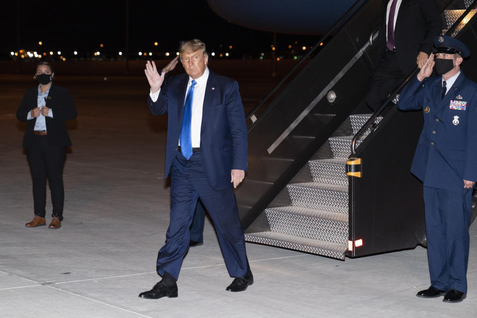 President Donald Trump waves as he steps off Air Force One at Las Vegas McCarran International Airport, Sunday, Oct. 18, 2020, in Las Vegas. (AP Photo/Alex Brandon)