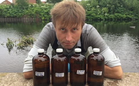 Julian Kirby of Friends of the Earth with water samples in the River Irwell - Credit: Friends of the Earth