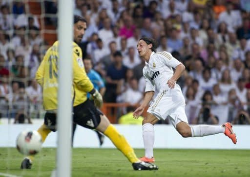 Real Madrid midfielder Mesut Ozil (R) scores past Mallorca goalkeeper Dudu Aouate during the La Liga football final against Mallorca on May 13. German international Ozil scored twice for Real