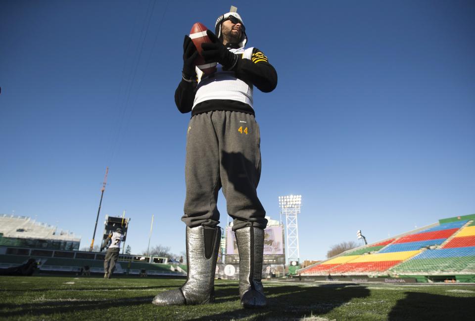 Hamilton Tiger-Cats kicker Josh Bartel of Australia wears warm boots in cold weather to protect his feet during their walk-through practice in Regina, Saskatchewan, November 23, 2013. The Hamilton Tiger-Cats will play the Saskatchewan Roughriders in the CFL's 101st Grey Cup in Regina on November 24. REUTERS/Mark Blinch (CANADA - Tags: SPORT FOOTBALL)